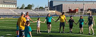 Kids holding hands at the Plaster Athletic Complex