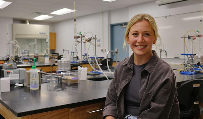 Peyton in the chemistry lab, smiling for the camera